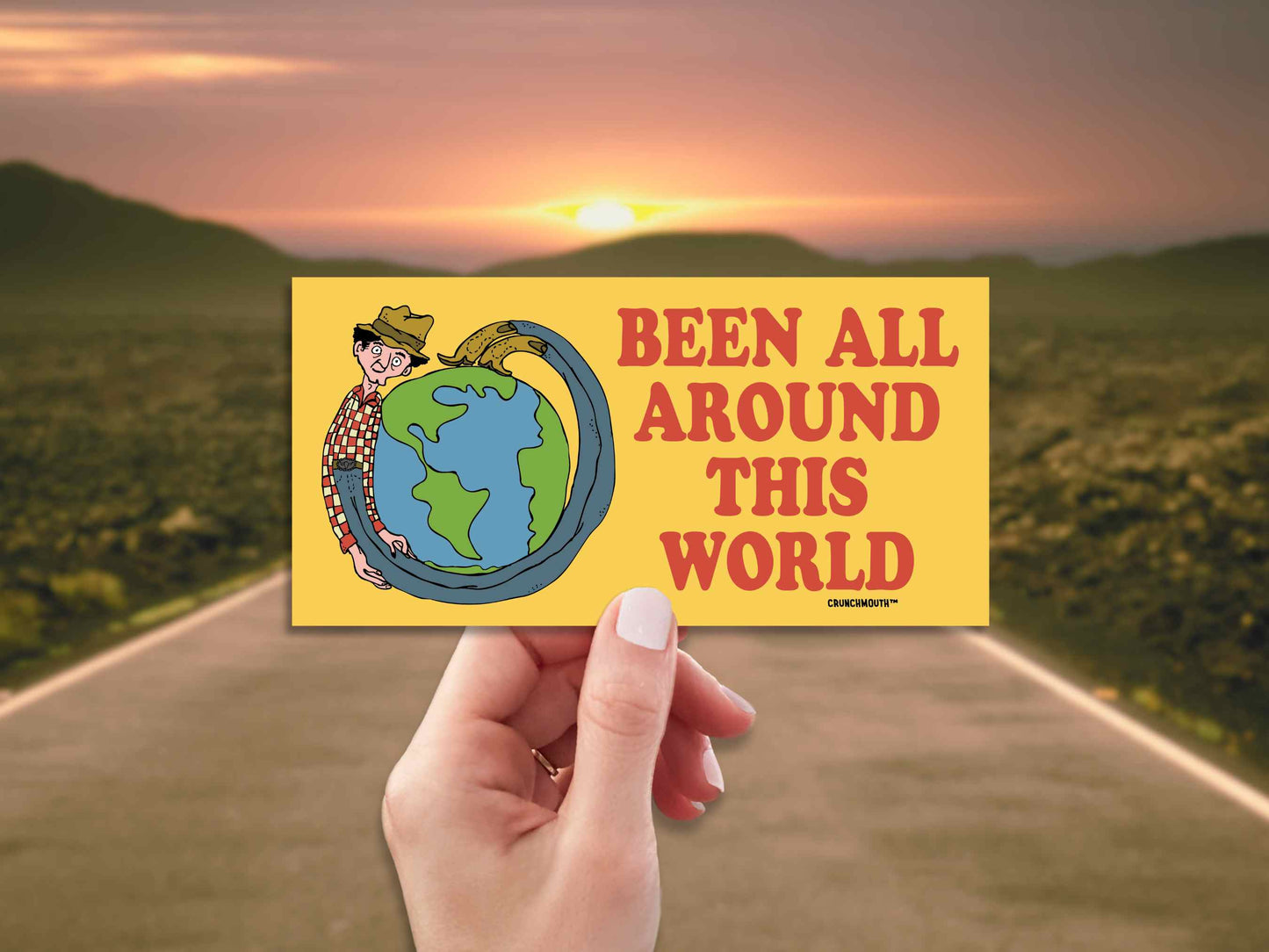 been all around this world bumper sticker, hand display, open road background
