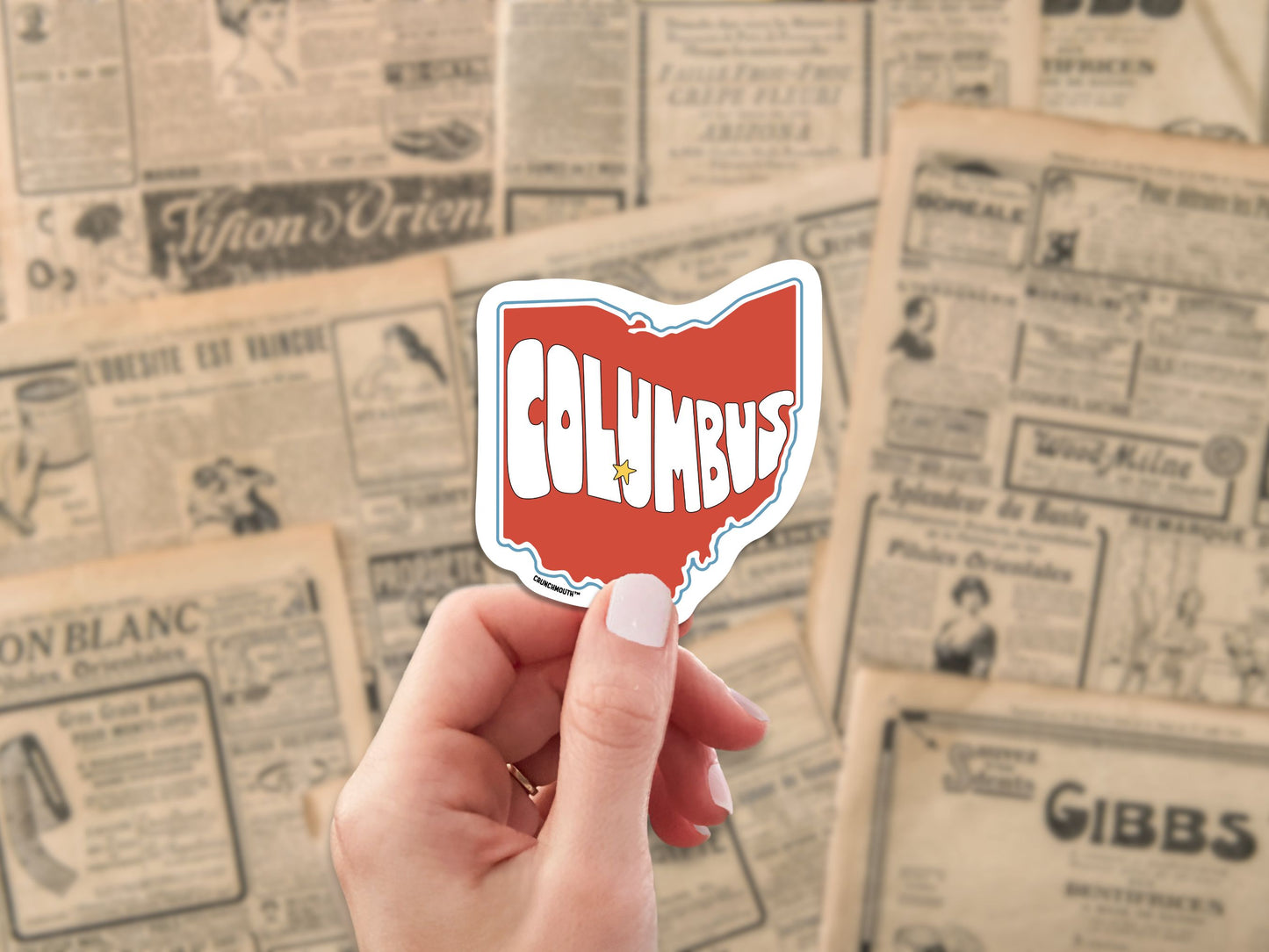 columbus ohio travel luggage sticker, hand display, antique newspaper ads background