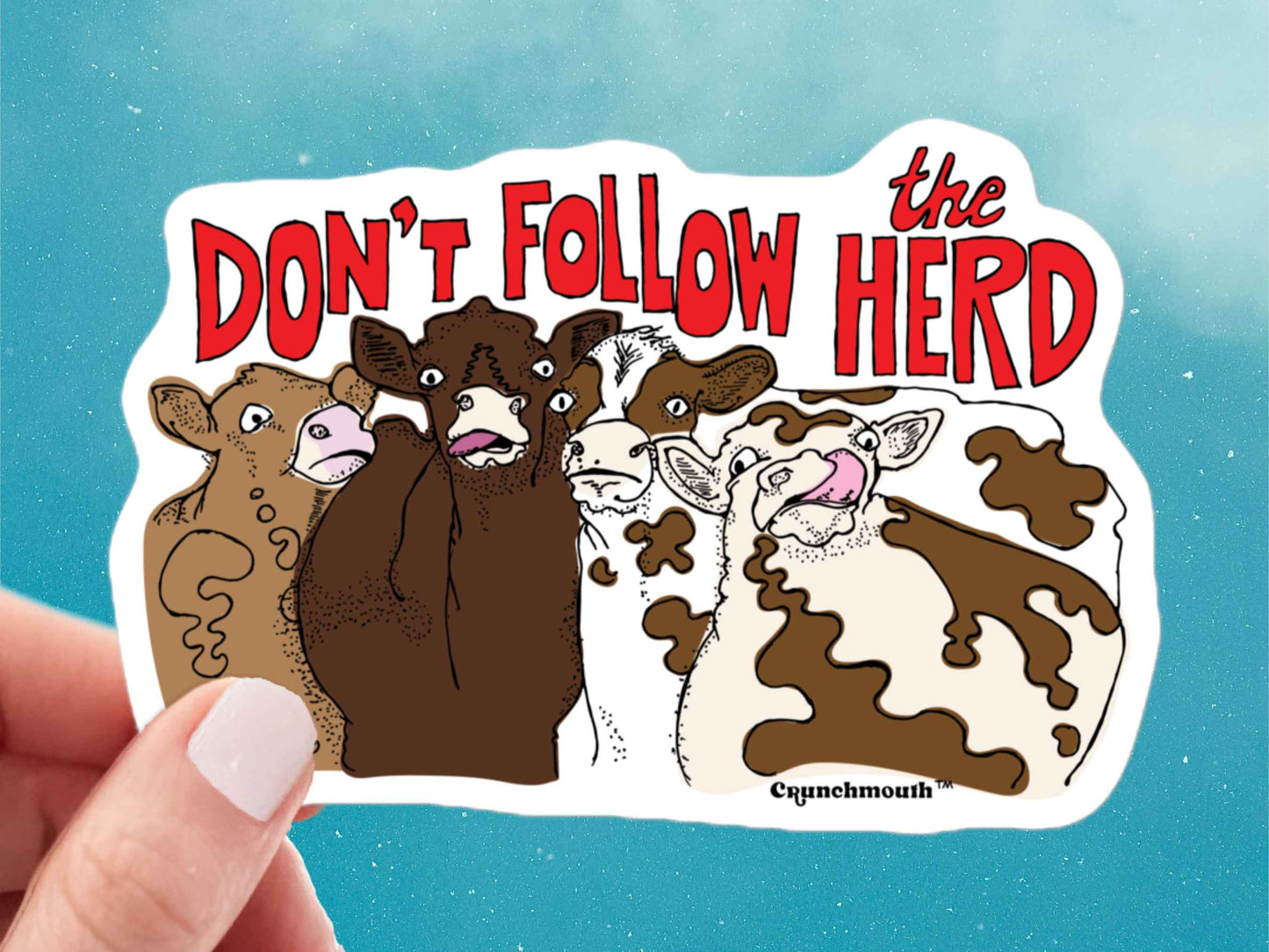 cow sticker, cow sticking tongue out, hand display, blue sky background