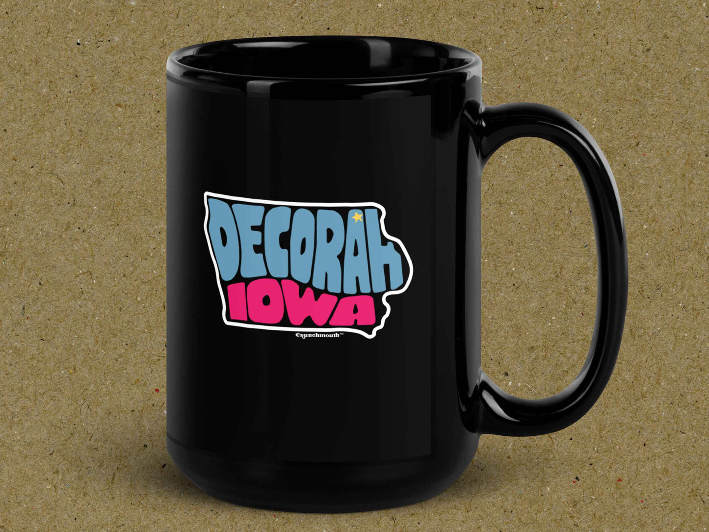 decorah mug, souvenir coffee mugs, 15oz, black ceramic, handle on right, brown textured background