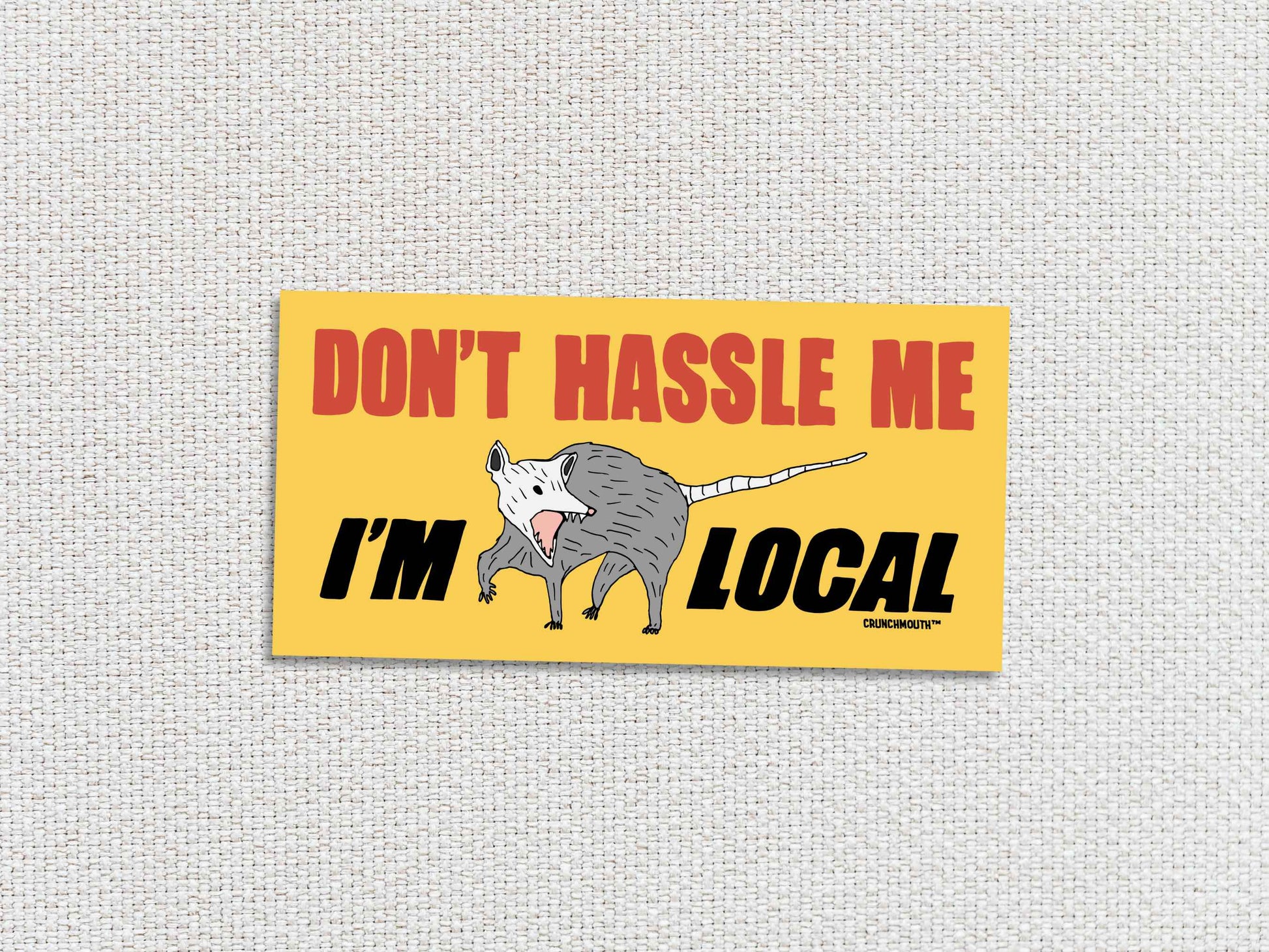 opossum bumper sticker, don't hassle me i'm local, funny bumper stickers, hand display, white textured background