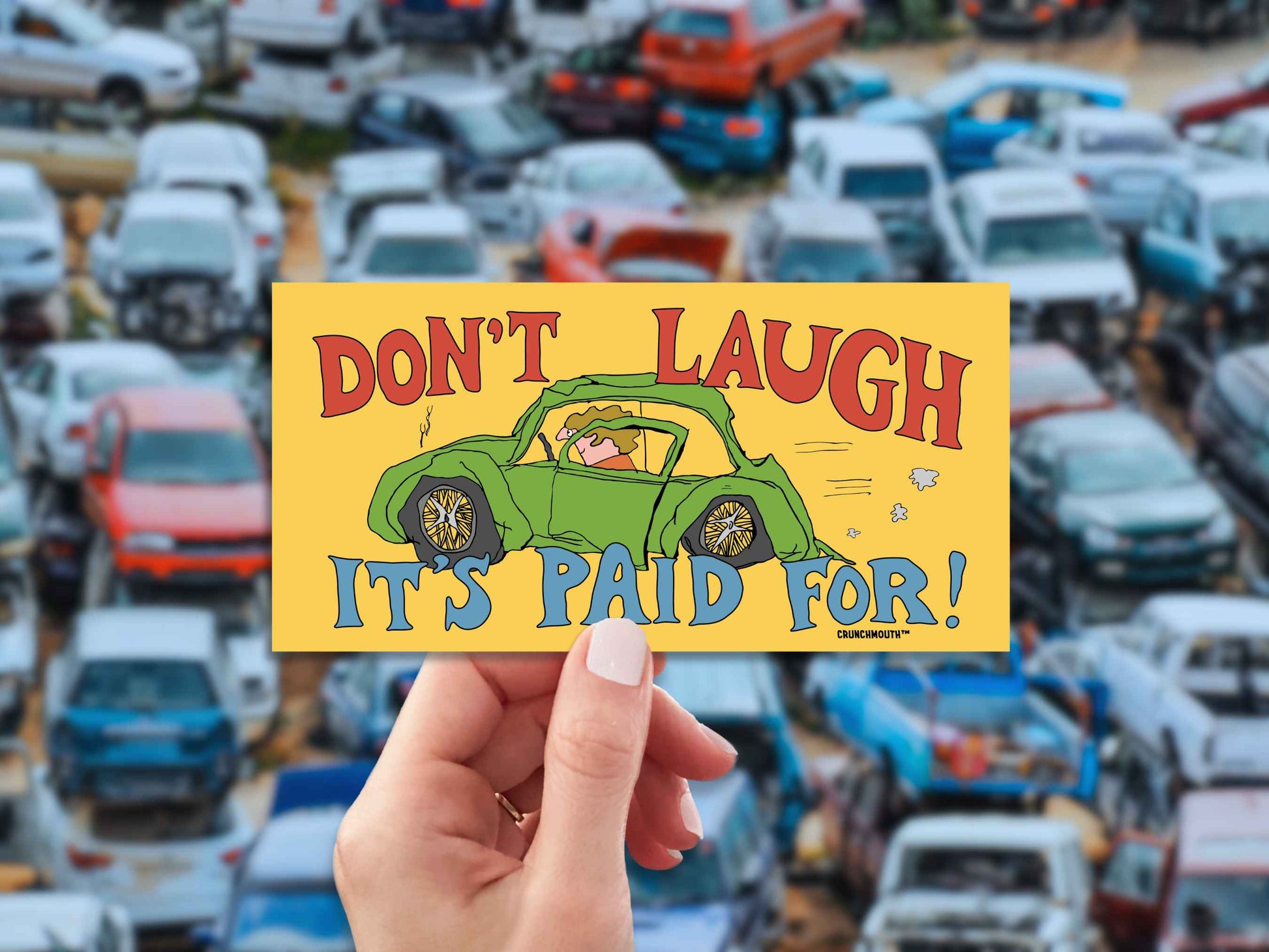 don't laugh it's paid for, funny bumper stickers, hand display, junkyard background