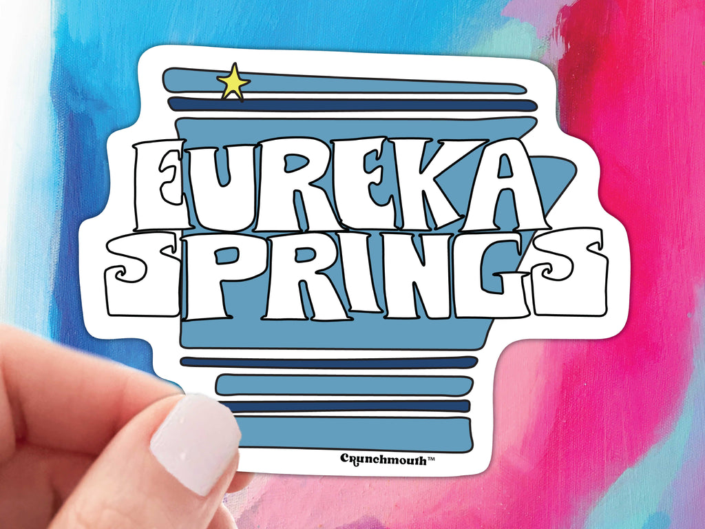 eureka springs arkansas sticker, held by hand, colorful watercolor background