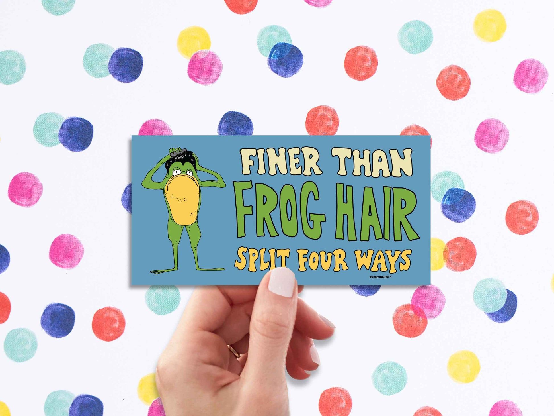 finer than frog hair split four ways bumper sticker, funny greaser frog combing hair, hand display, polka dots background