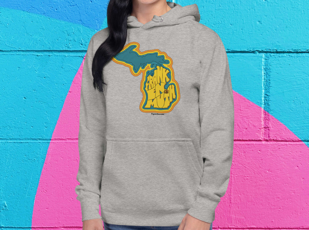 frankenmuth michigan hoodie, front, female, bold color cinder block wall background