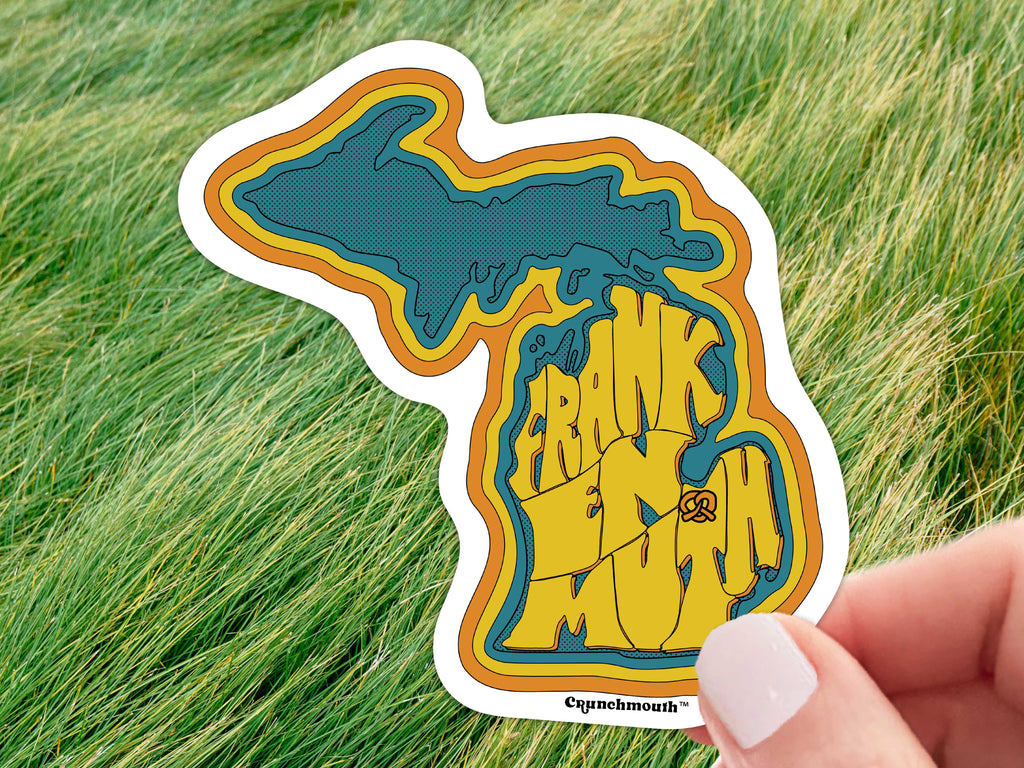 frankenmuth michigan sticker, held in hand, grass background