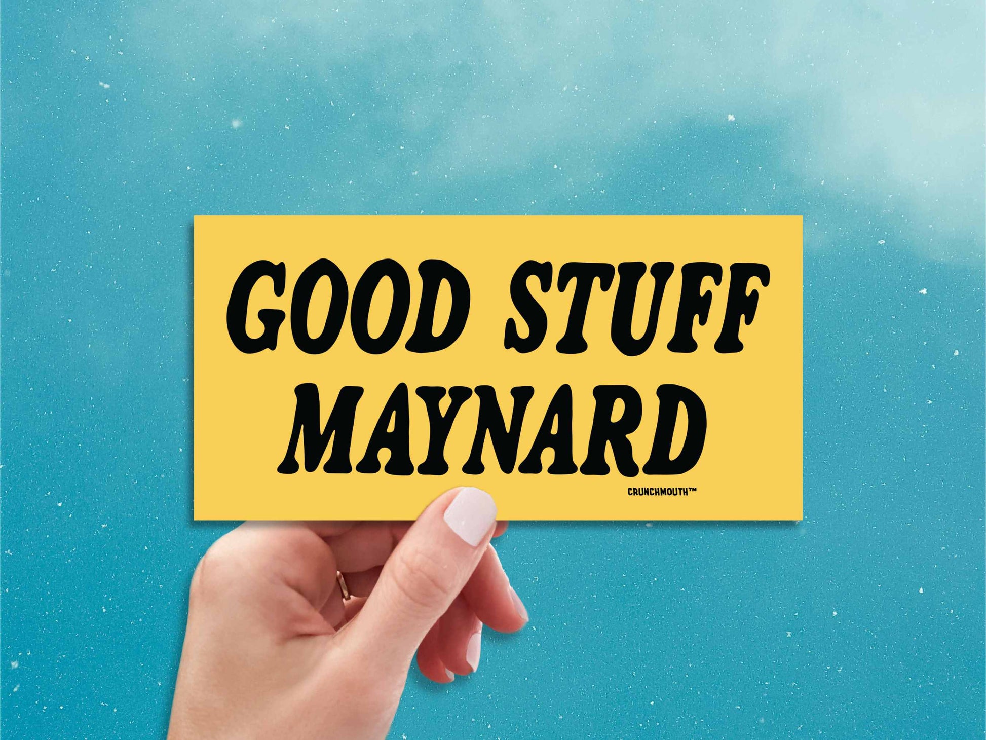 good stuff maynard bumper sticker, hand display, blue sky background