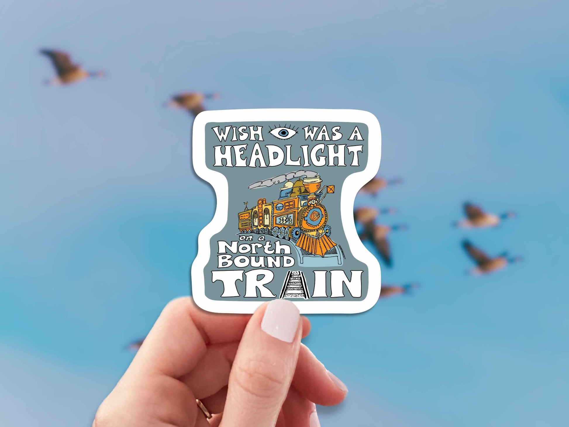 wish i was a headlight on a northbound train sticker, hand display, wild geese flying background