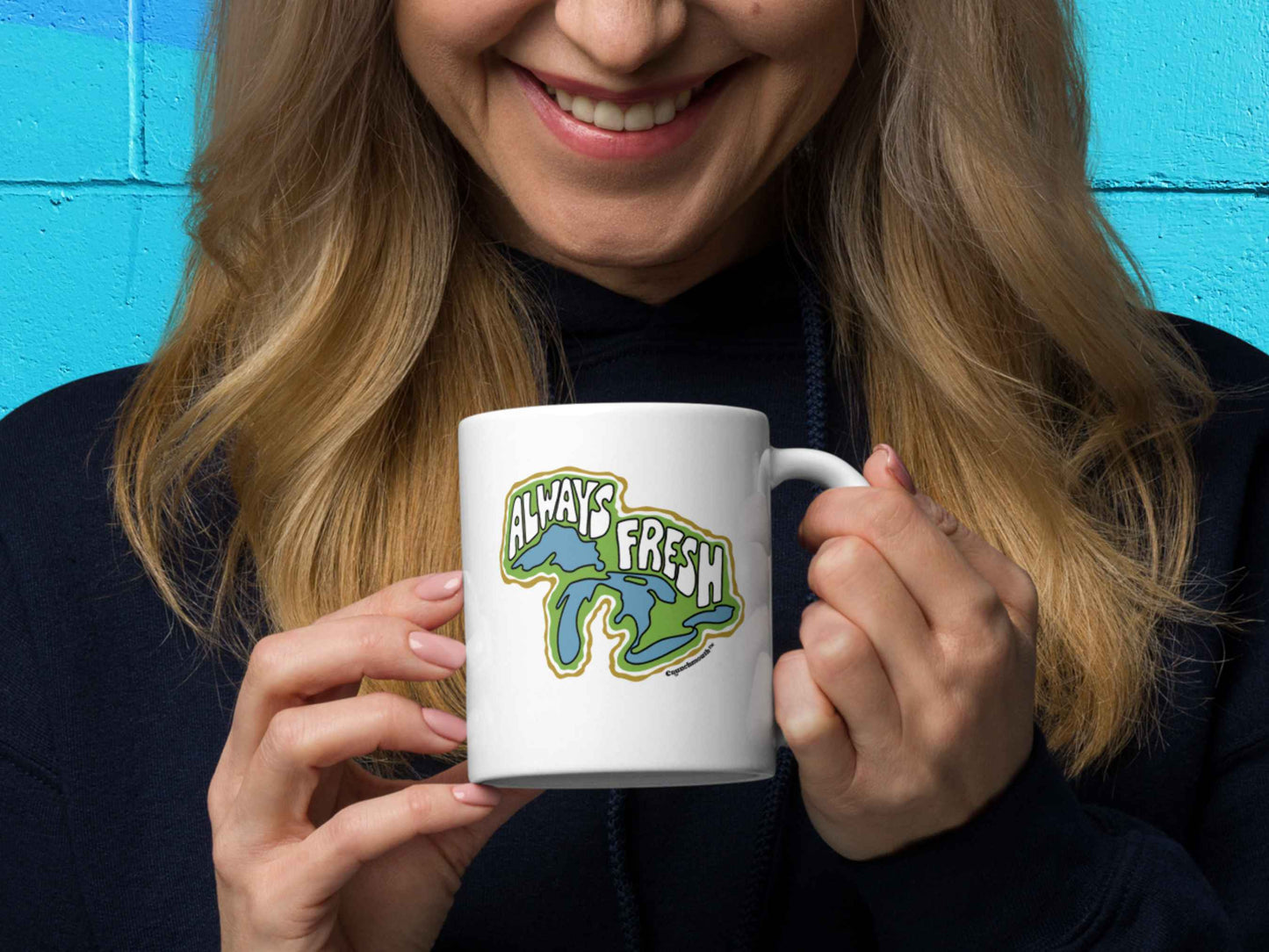 great lakes mug, retro coffee mugs, 11 oz, handle on right, held by female model, colorful cinder block wall background