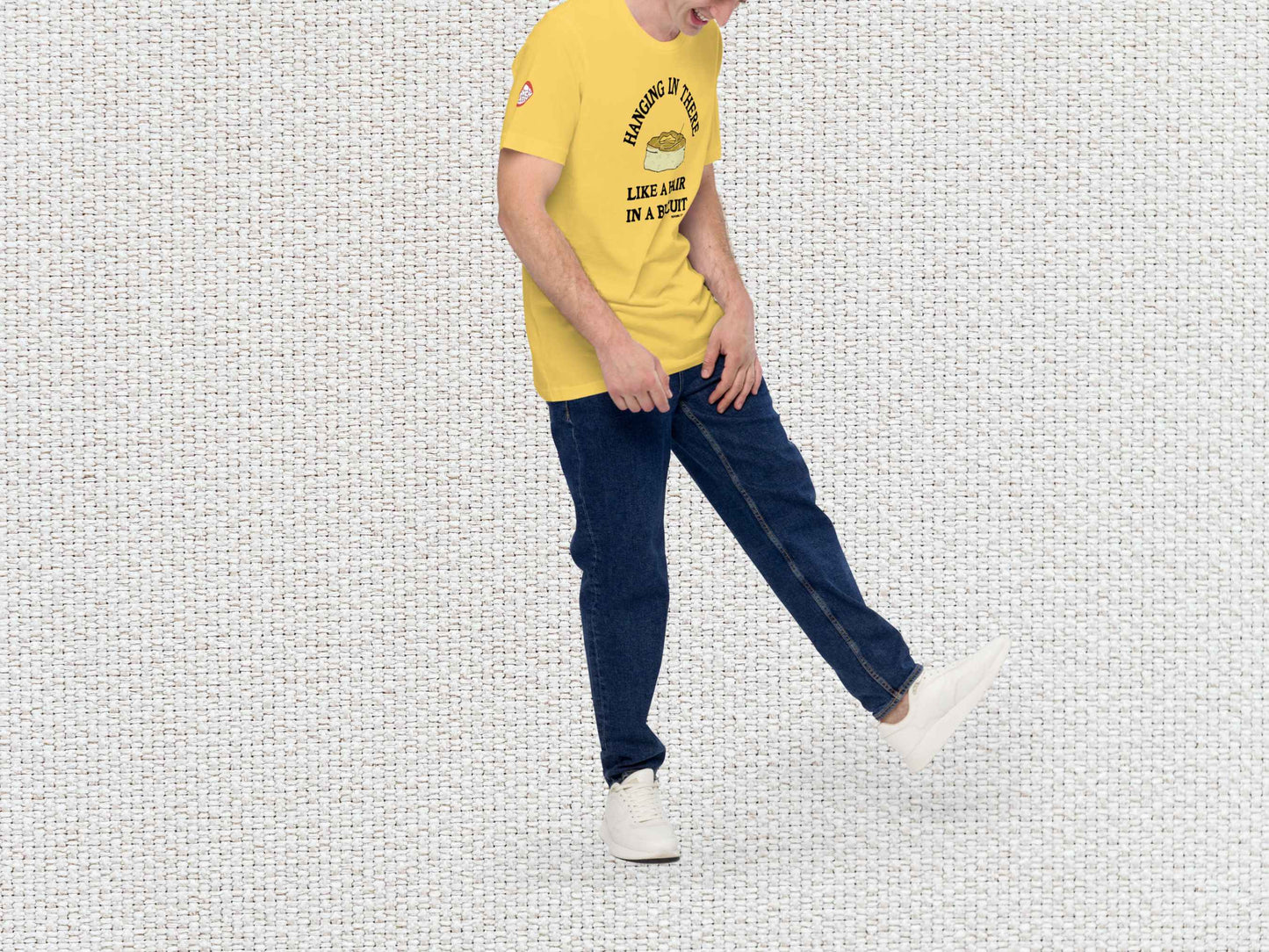 hanging in there like a hair in a biscuit shirt, funny t-shirts, male model, front right side, white textured background