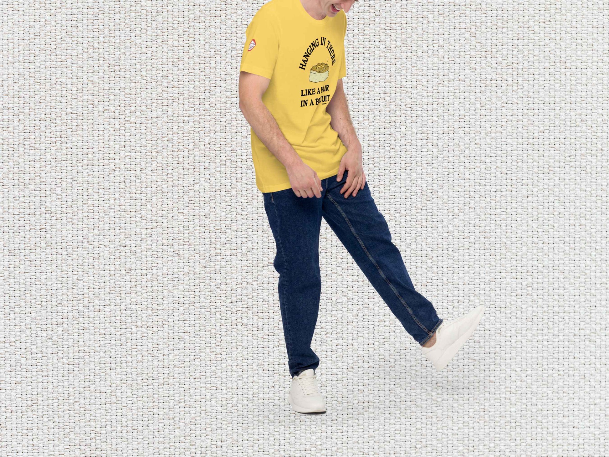 hanging in there like a hair in a biscuit shirt, funny t-shirts, male model, front right side, white textured background