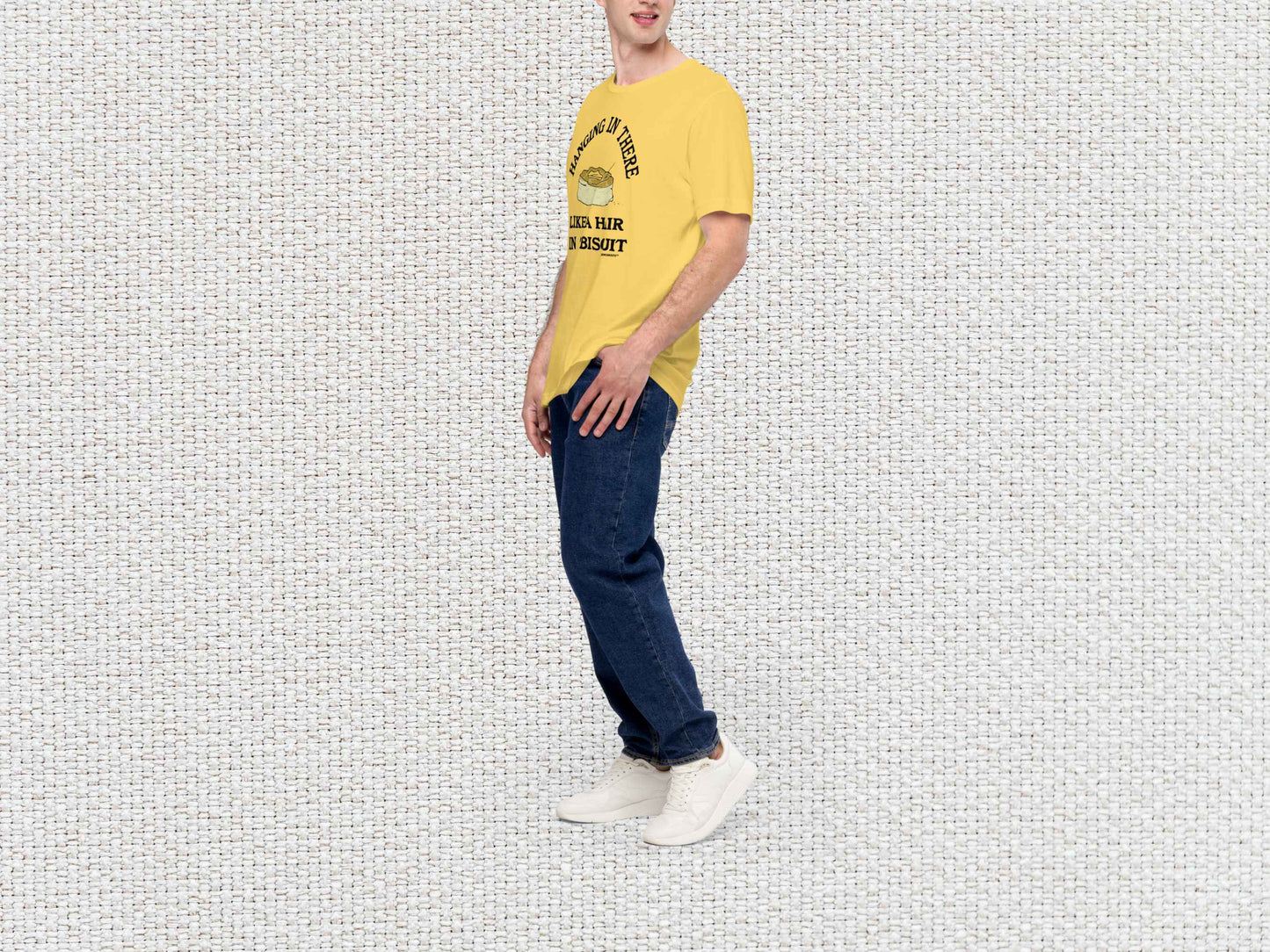 hanging in there like a hair in a biscuit shirt, funny t-shirts, male model, front left side, white textured background
