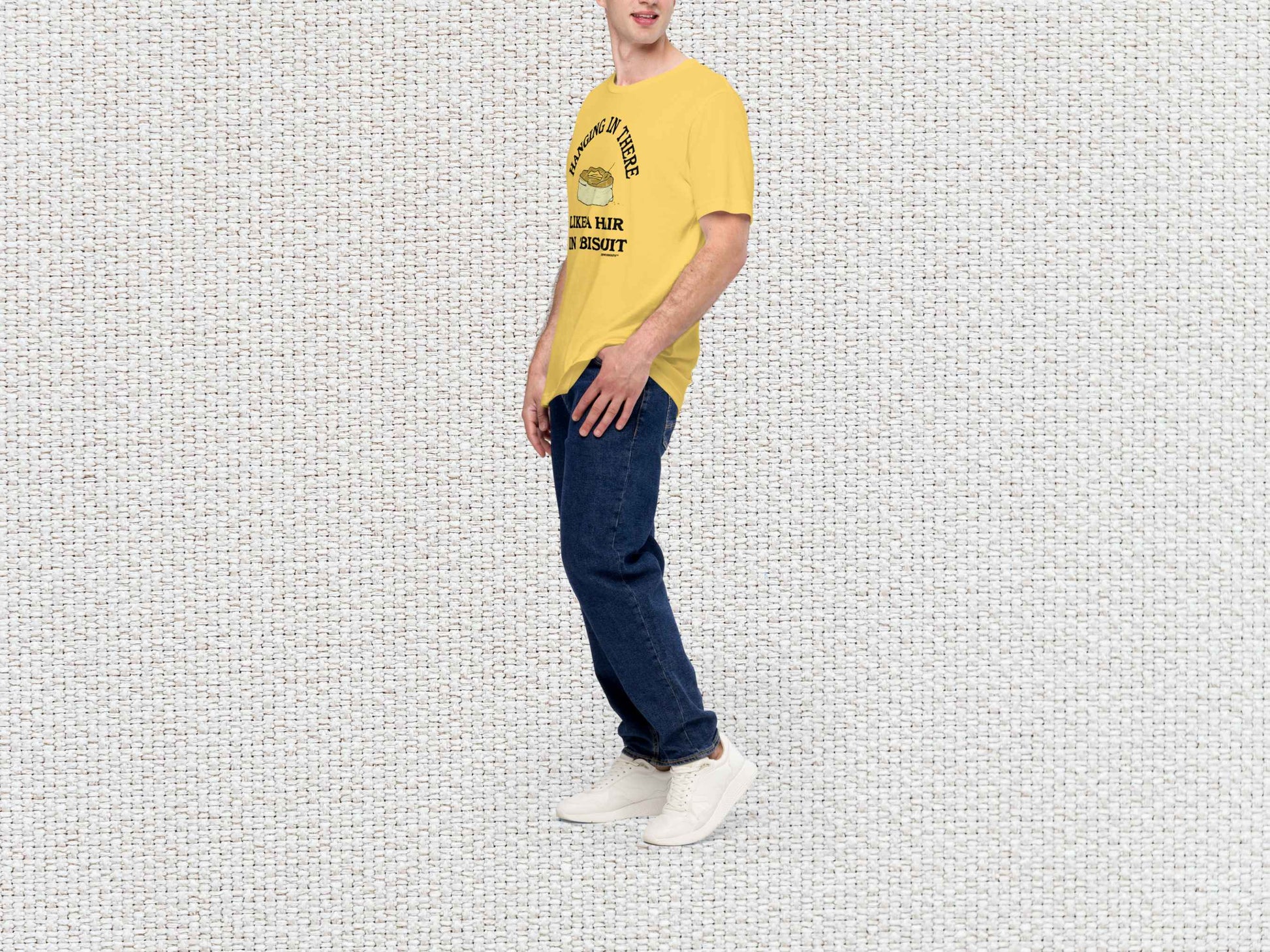 hanging in there like a hair in a biscuit shirt, funny t-shirts, male model, front left side, white textured background