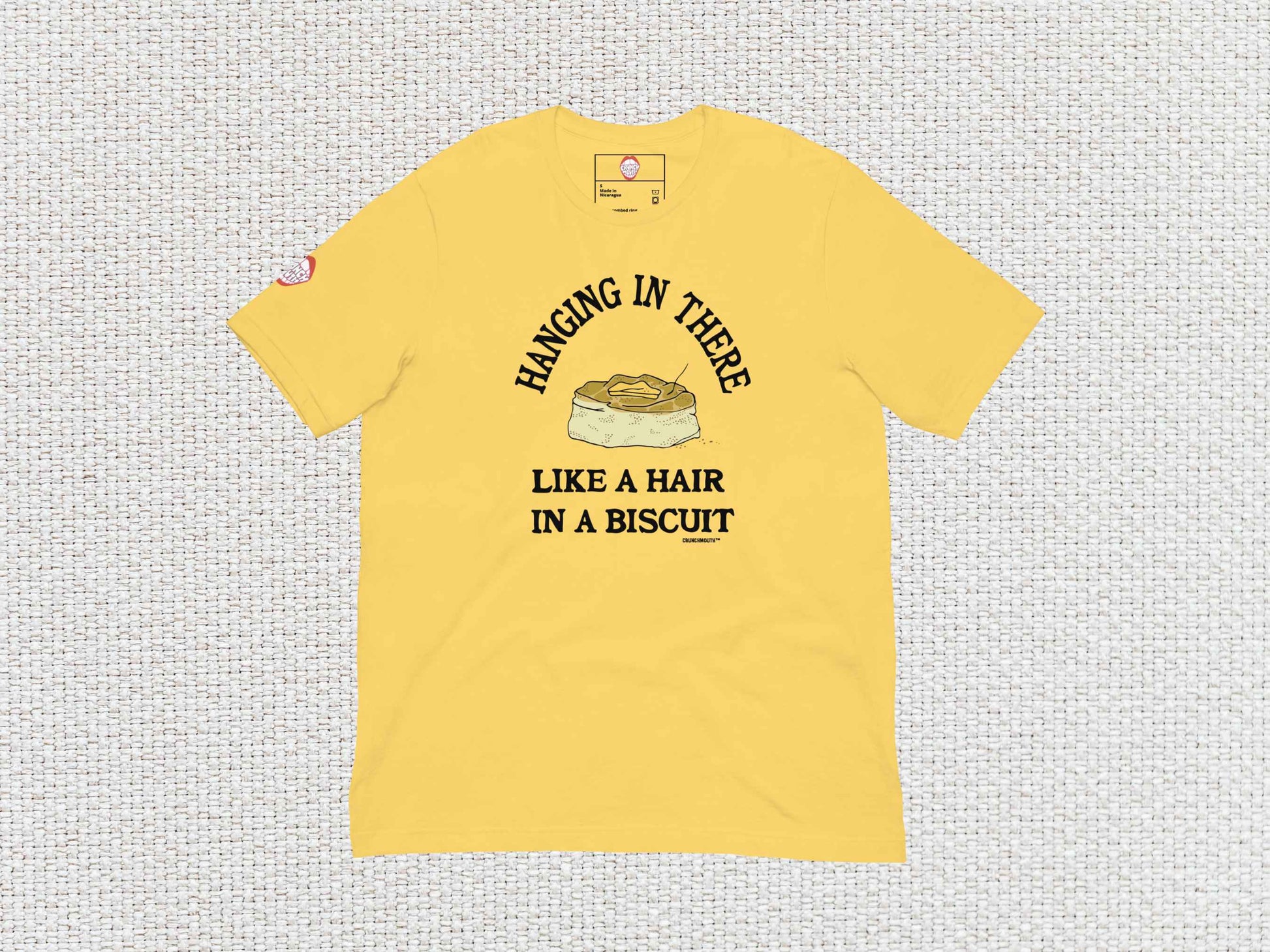 hanging in there like a hair in a biscuit shirt, funny t-shirts, flat, front, white textured background