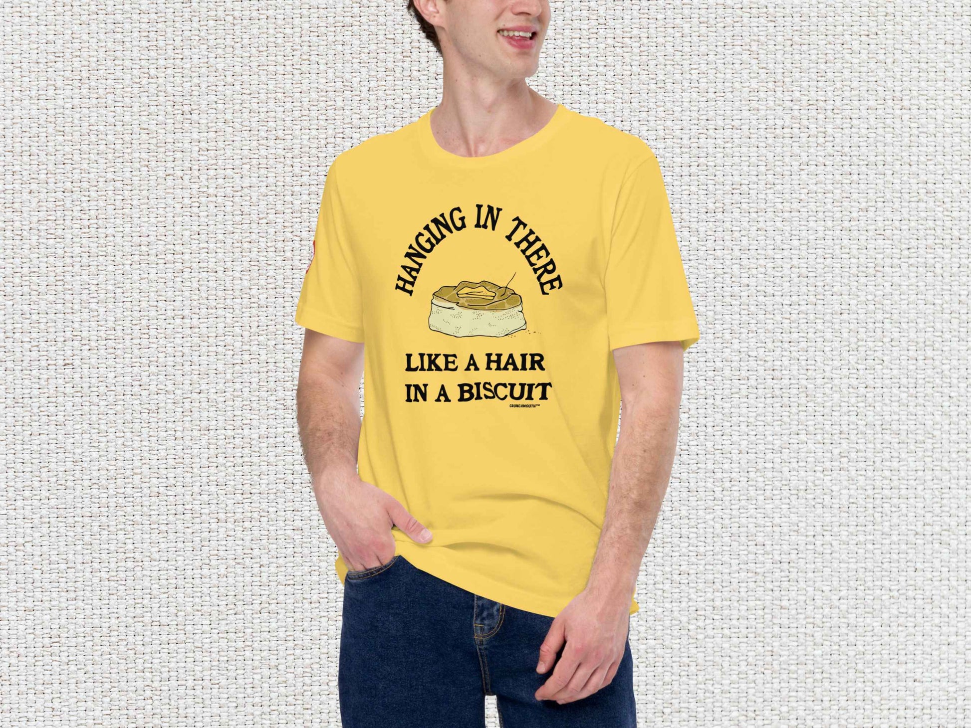 hanging in there like a hair in a biscuit shirt, funny t-shirts, male model, front, white textured background