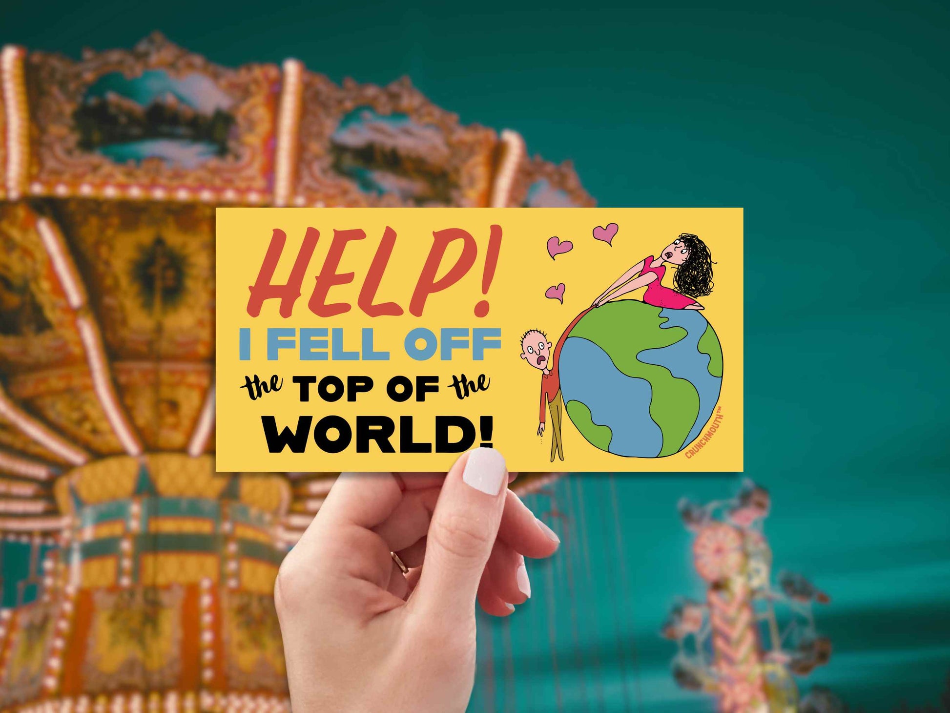 help i fell off the top of the world bumper sticker, hand display, amusement park background