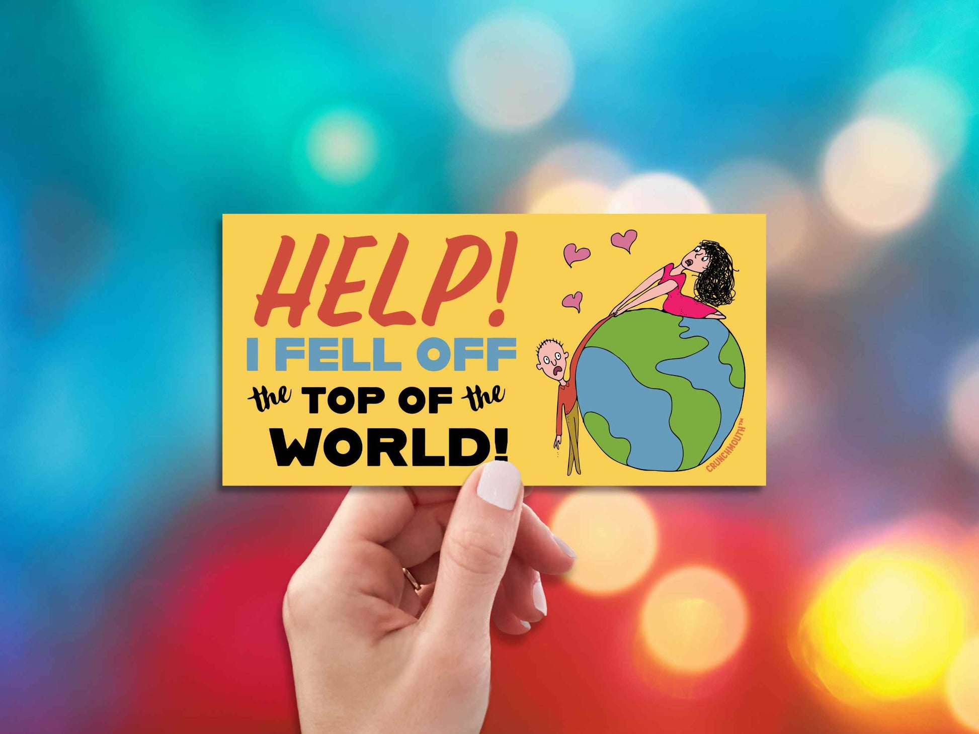 help i fell off the top of the world bumper sticker, hand display, colorful lights background