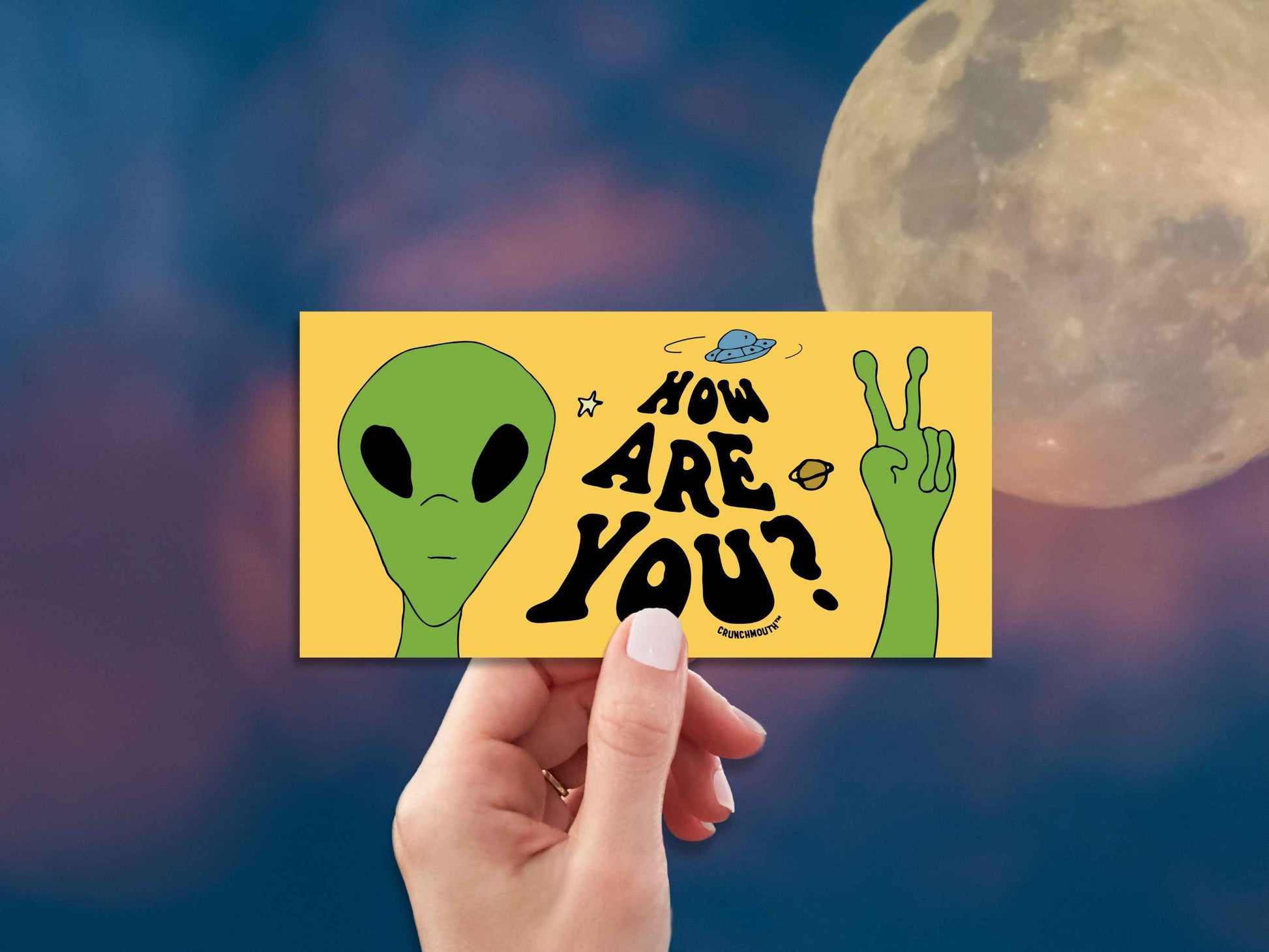 how are you? bumper sticker, green alien, martian from outer space, hand display, moon night sky background