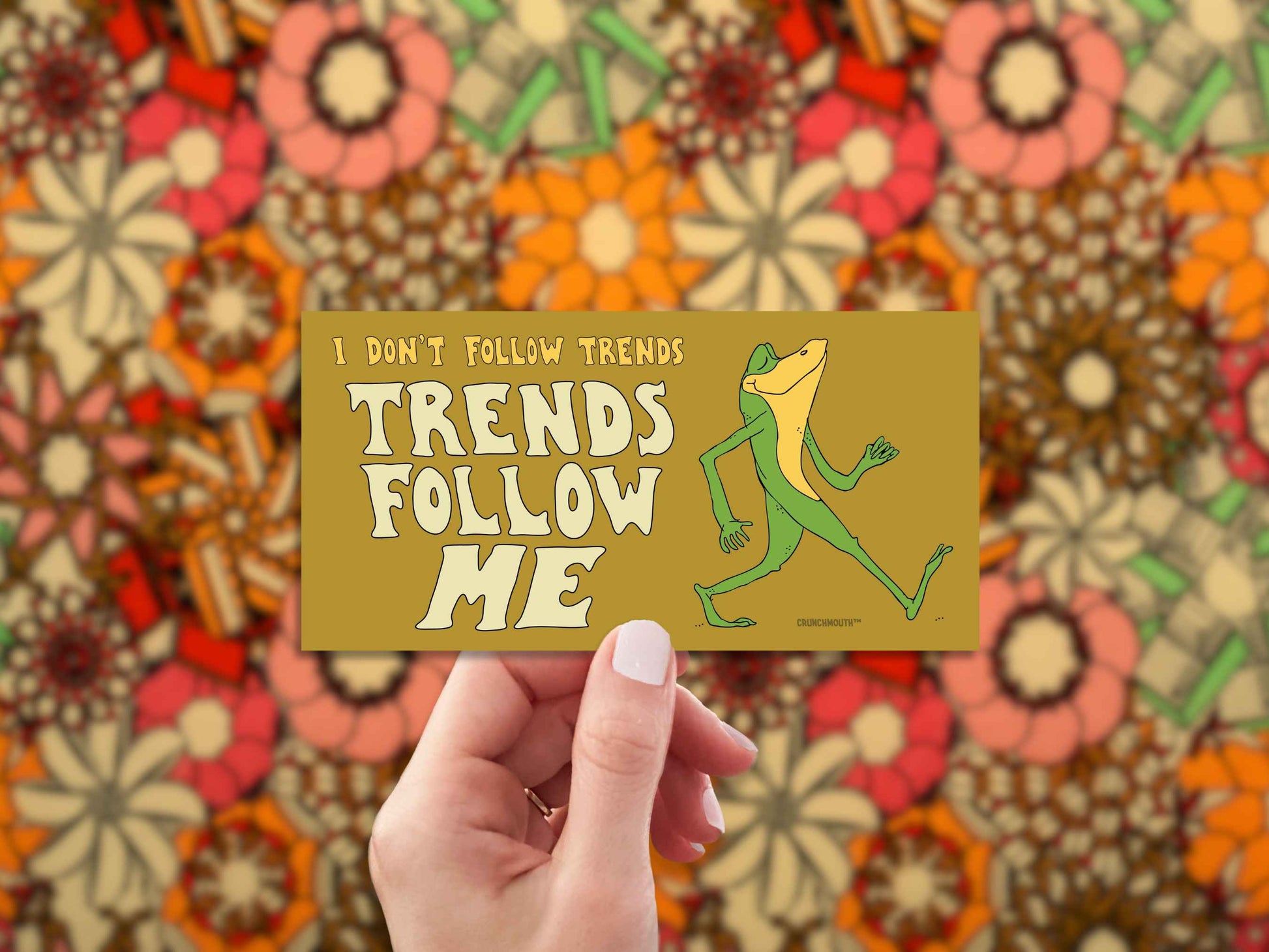 i don't follow trends, trends follow me bumper sticker, hand display, 1960s fabric pattern background