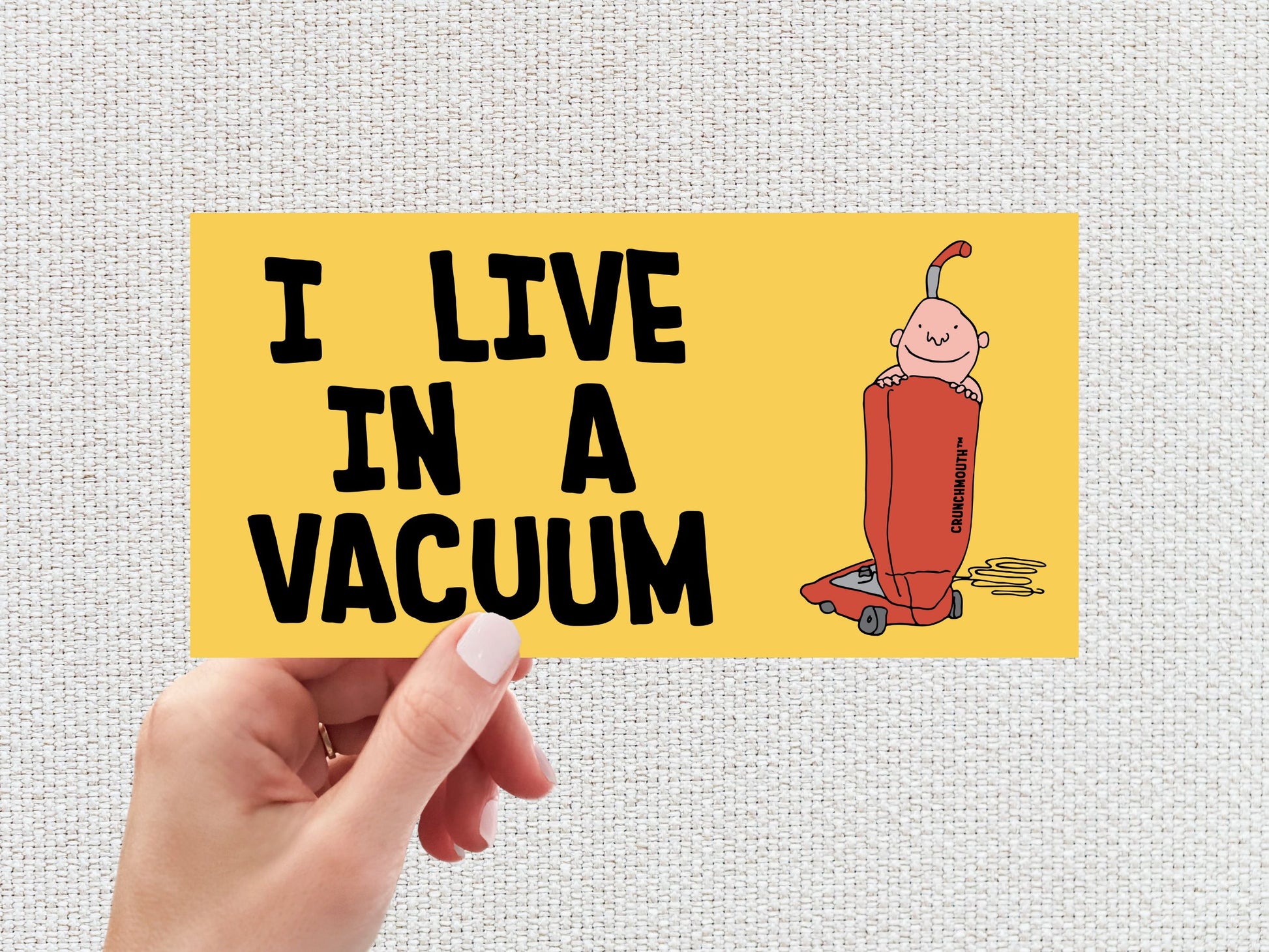 i live in a vacuum bumper sticker, hand display, white textured background