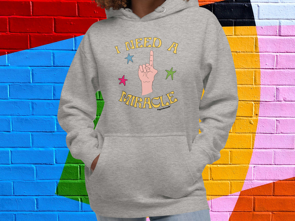 i need a miracle hoodie, front, female, colorful brick wall background