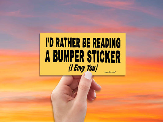 i'd rather be reading a bumper sticker (i envy you), funny bumper stickers, hand display, red sky background