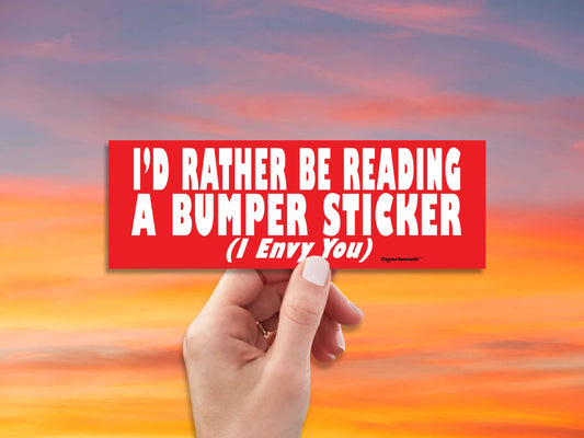 i'd rather be reading a bumper sticker (i envy you), funny bumper stickers, hand display, red sky background