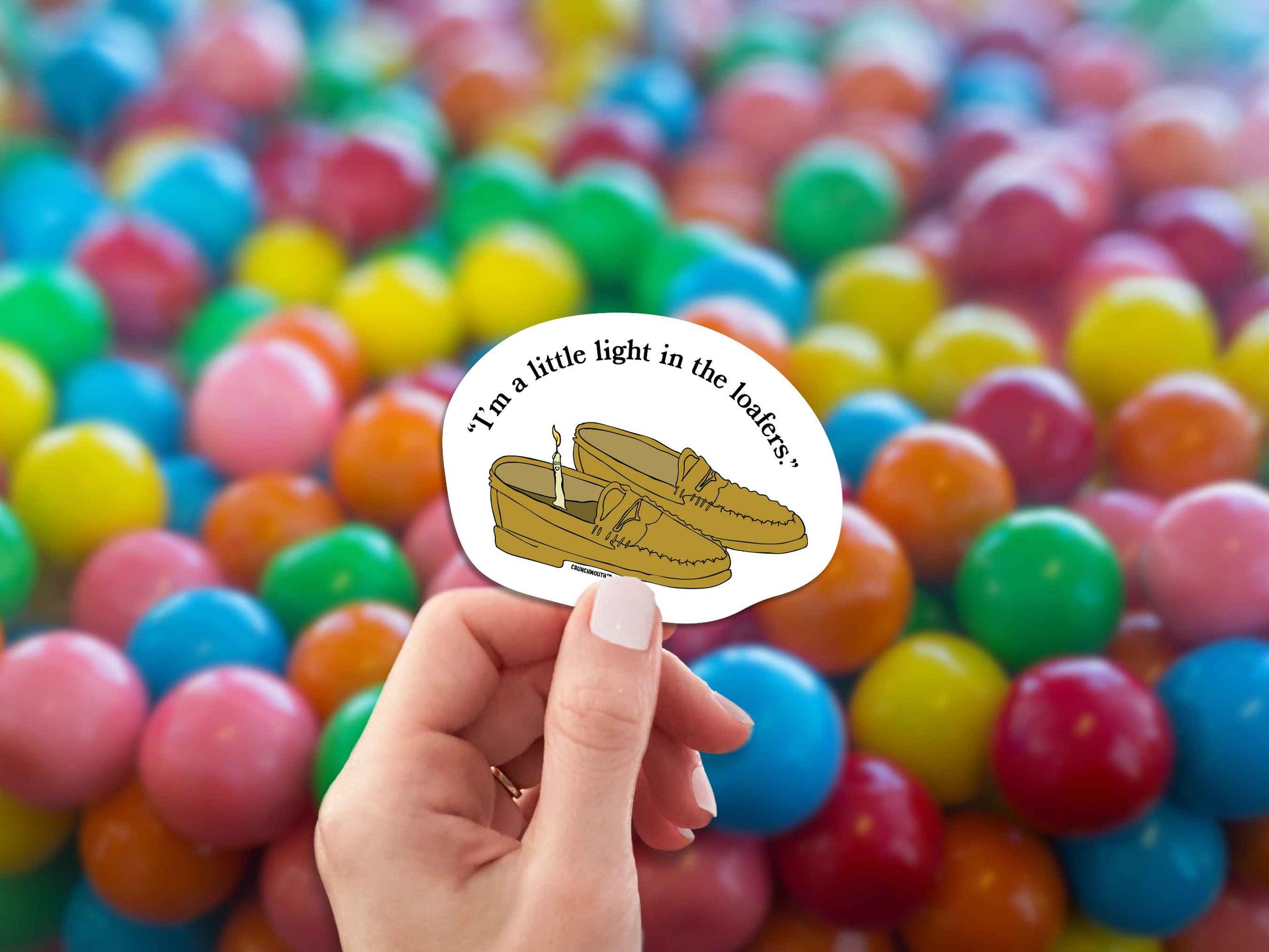 i'm a little light in the loafers funny pun sticker, hand display, bubble gum background