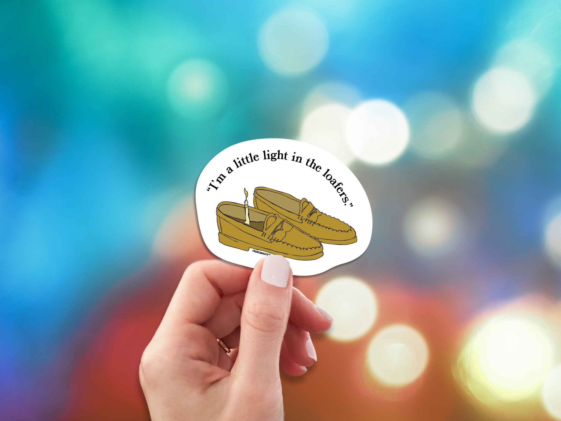 i'm a little light in the loafers funny pun sticker, hand display, bright colorful lights background