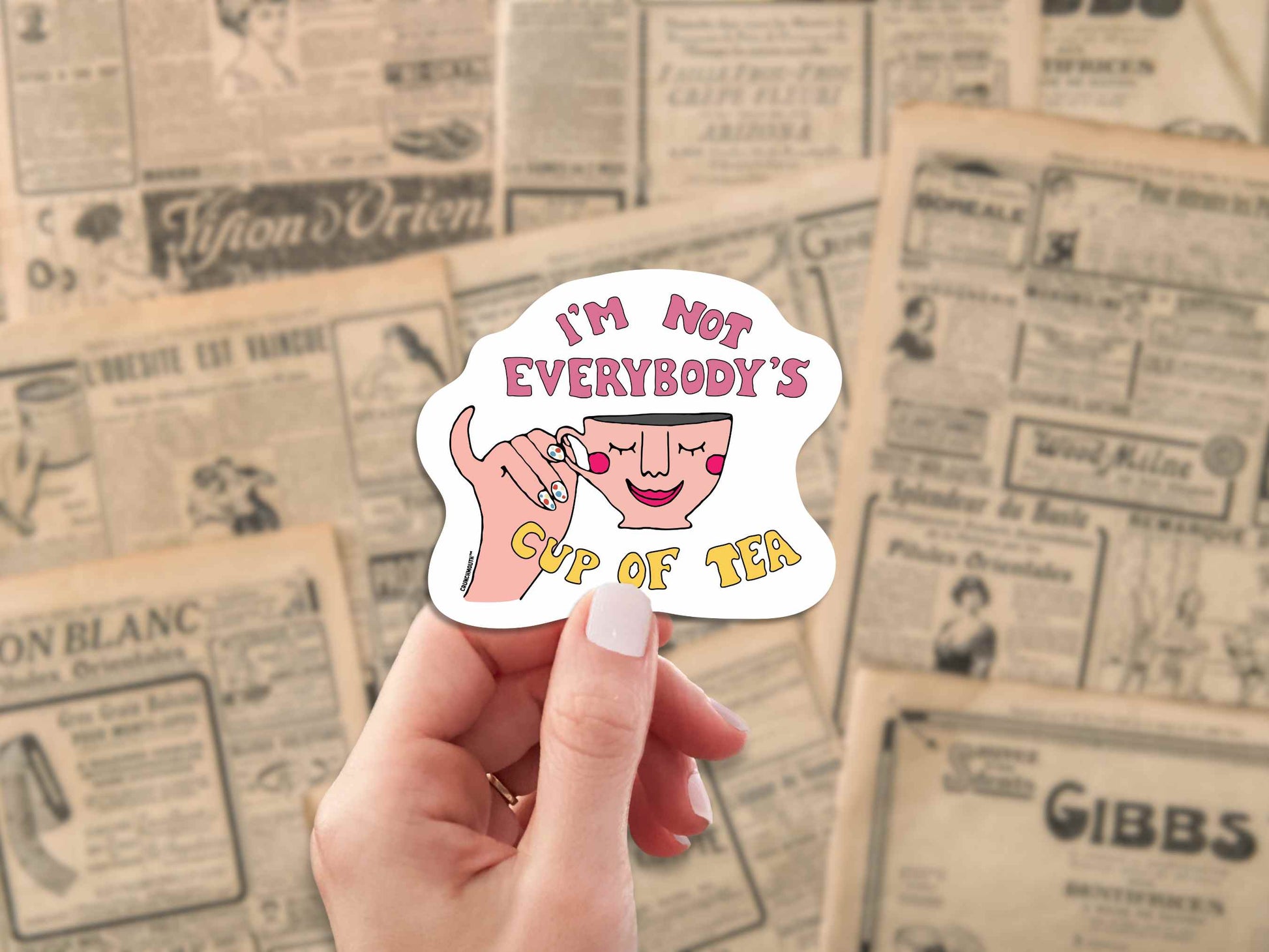 i'm not everybody's cup of tea laptop sticker, hand display, antique newspaper advertisements background