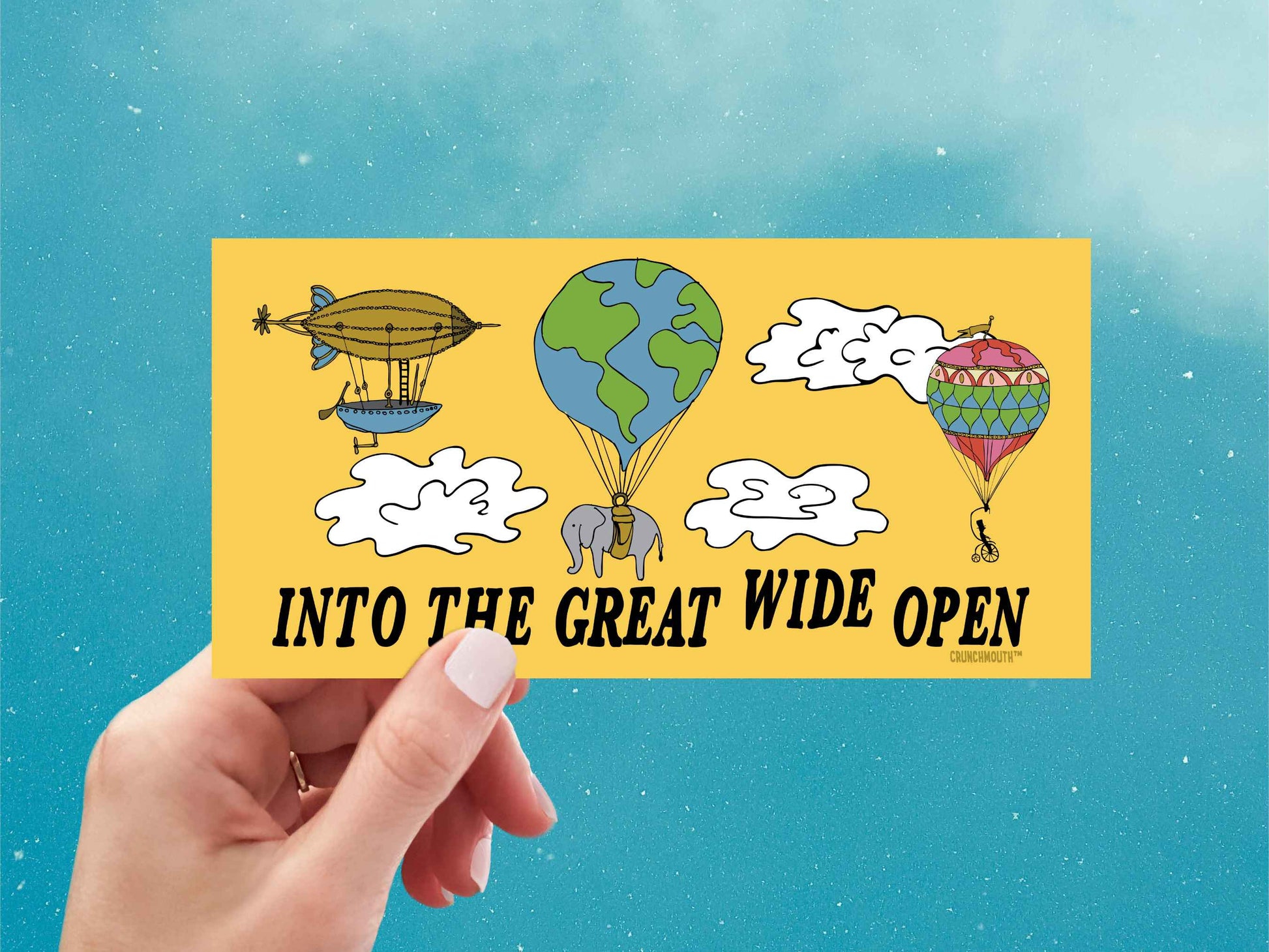 into the great wide open bumper sticker, hand display, blue sky background