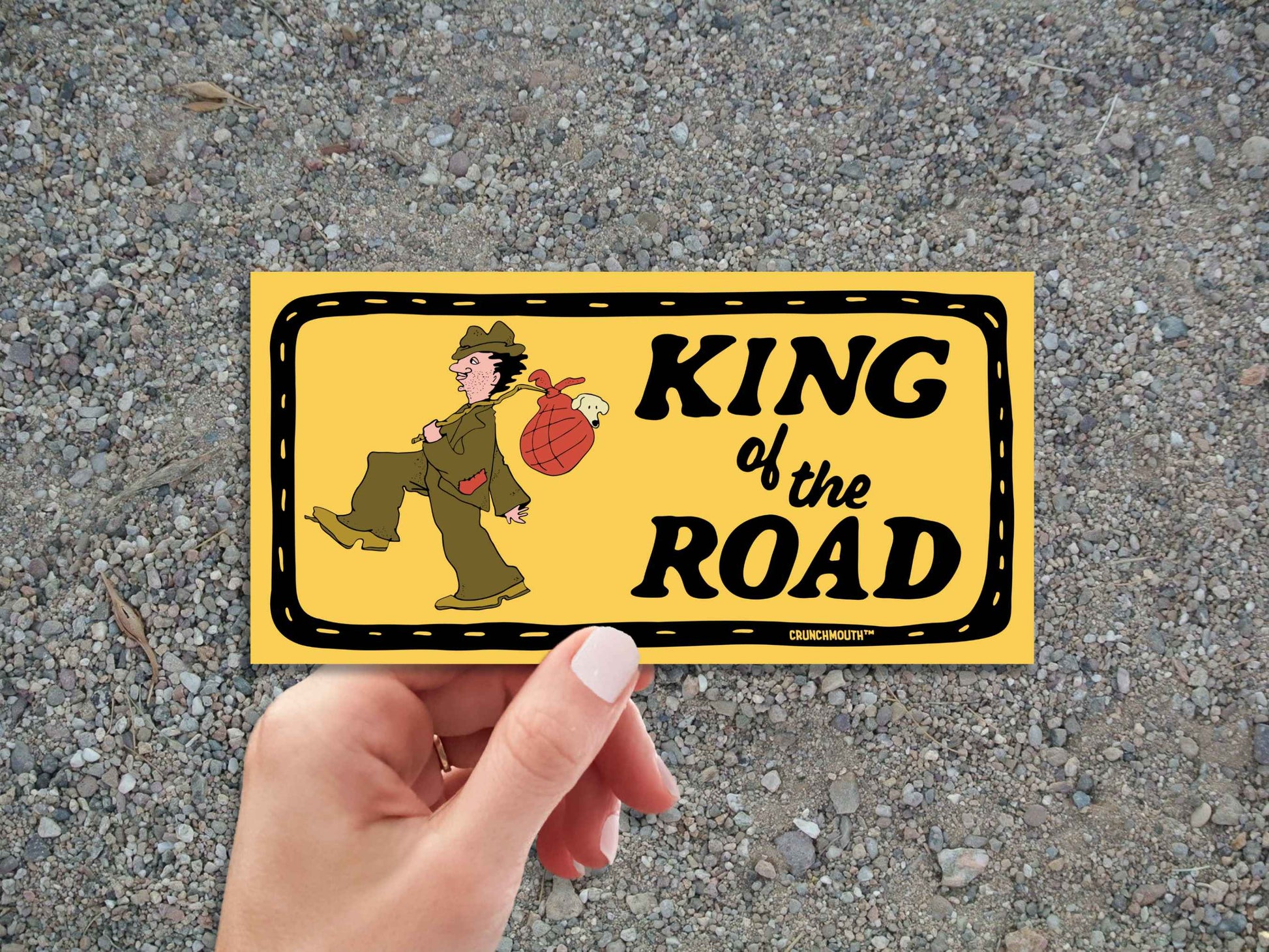 king of the road bumper sticker, hand display, gravel road background