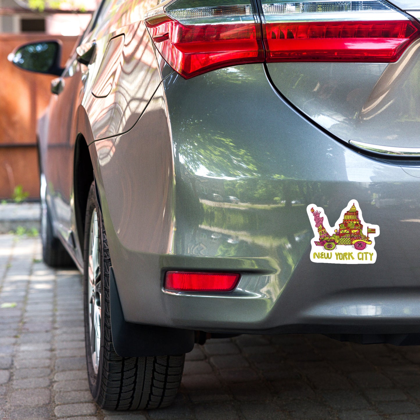 five inch new york city vinyl sticker displayed on rear bumper of car