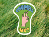 thumbs up sticker, green grass background