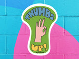 thumbs up sticker, colorful cinder block wall background