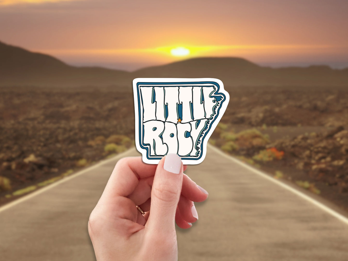 little rock travel luggage sticker, hand display, highway background