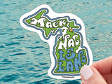 mackinac island waterproof vinyl sticker, held in hand, water background
