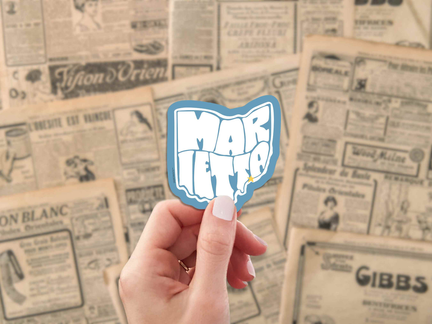 marietta ohio travel luggage sticker, hand display, old newspaper ads background