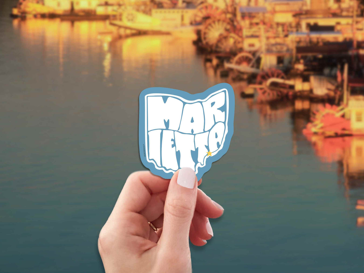 marietta ohio travel luggage sticker, hand display, sternwheel boats on river background