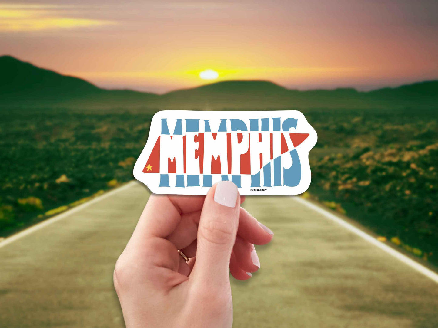 memphis travel luggage sticker, hand display, open road highway sunset background