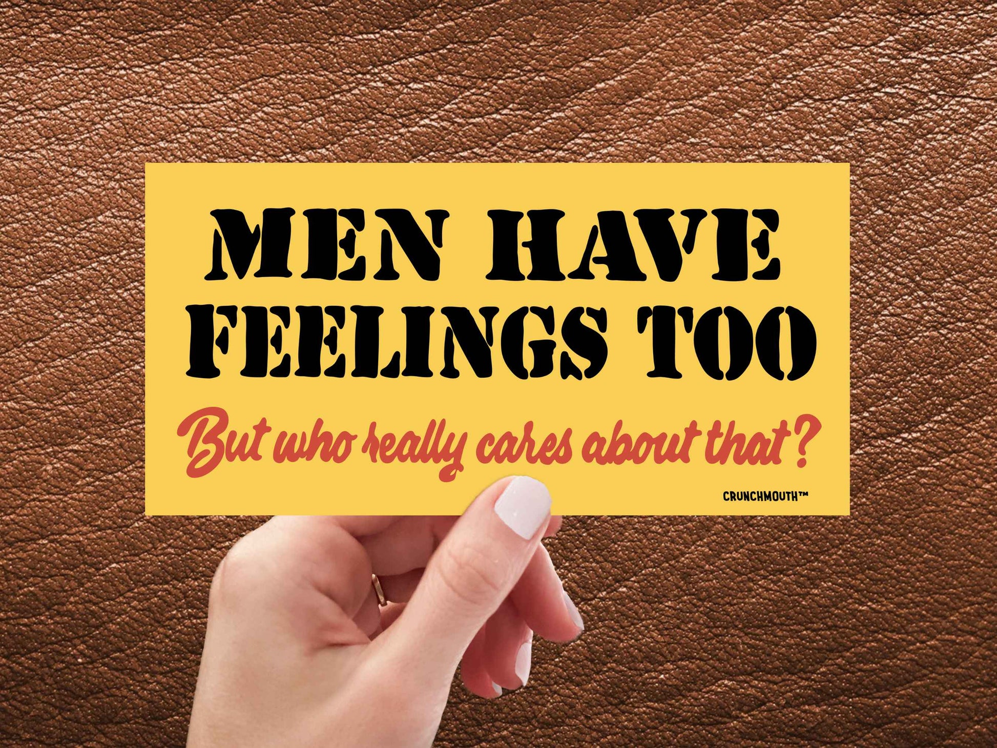 men have feelings too but who really cares about that funny bumper sticker, hand display, brown leather background