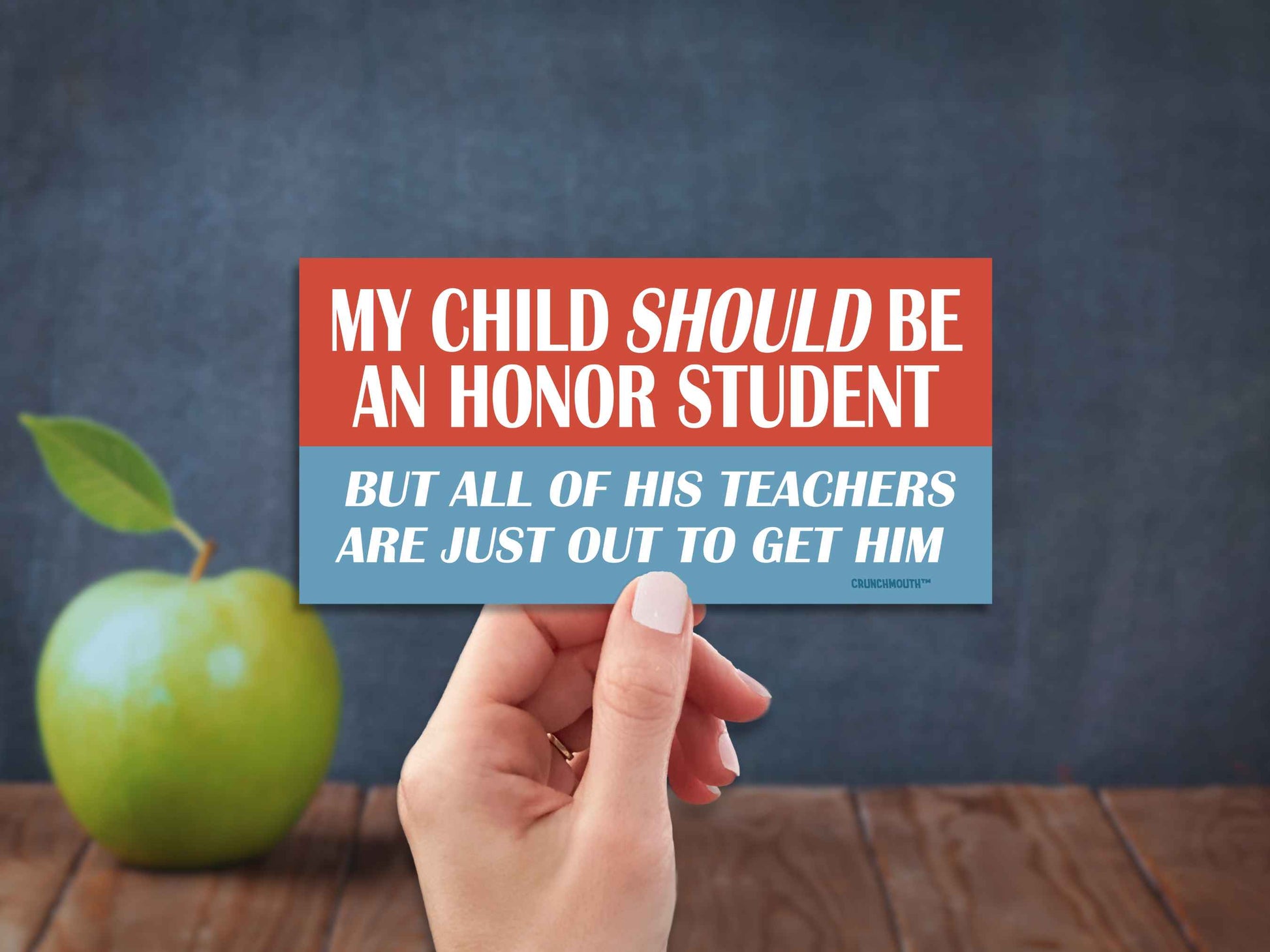 my child should be an honor student but all of his teachers are just out to get him bumper sticker, hand display, blackboard apple background