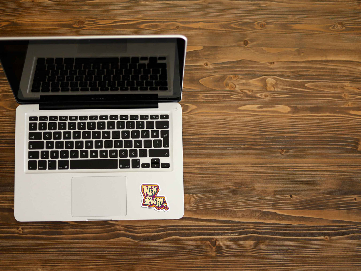 new orleans travel luggage sticker, displayed on laptop