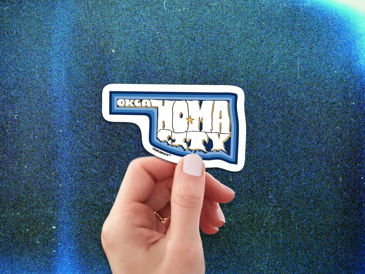 oklahoma city travel luggage sticker, hand display, noisy blue film frame background