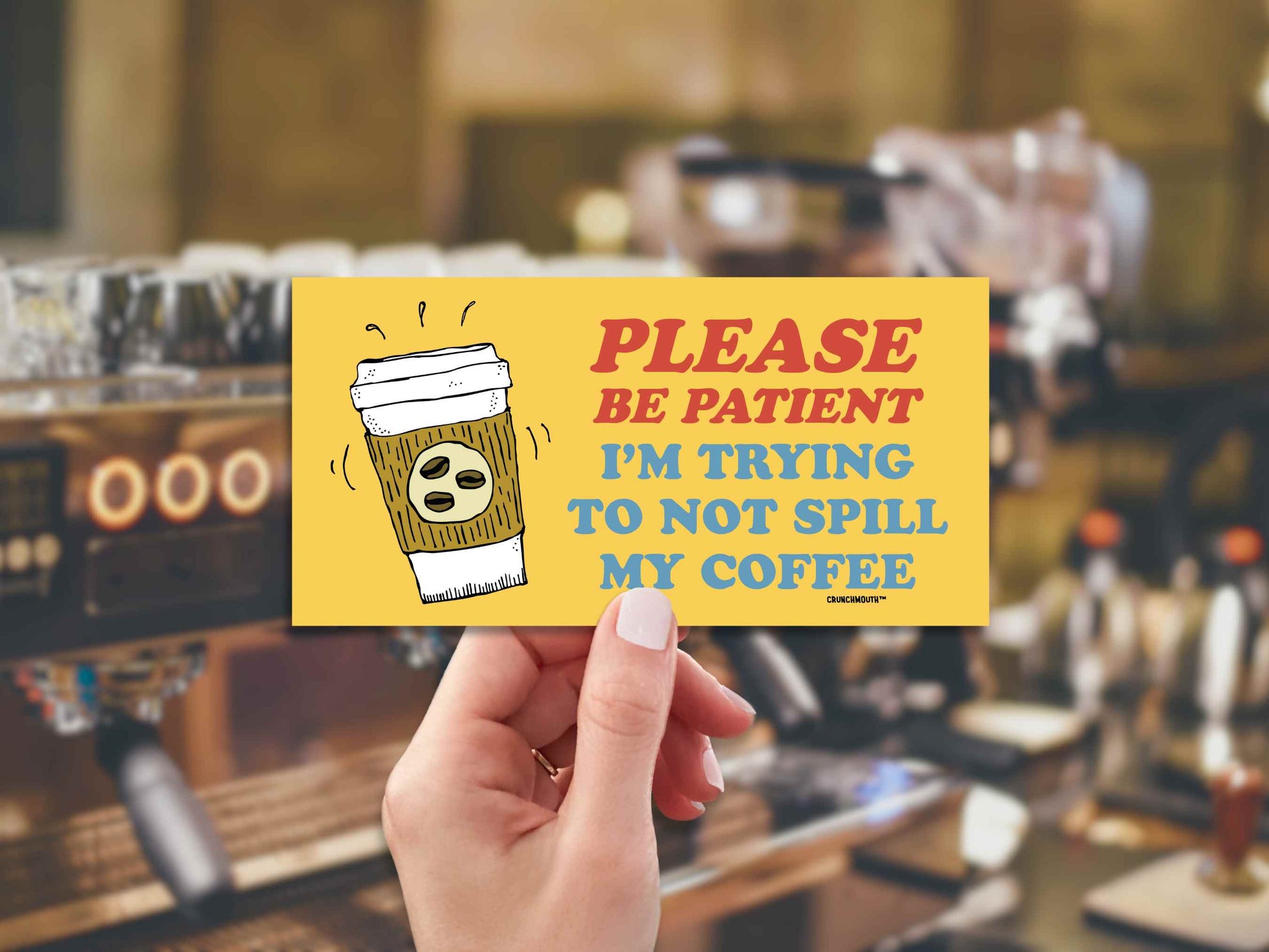 please be patient I'm trying to not spill my coffee, funny bumper sticker, hand display, coffee machine background