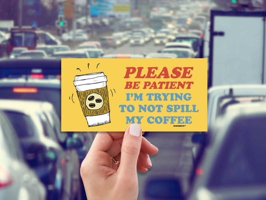 please be patient I'm trying to not spill my coffee, funny bumper sticker, hand display, stuck in traffic background