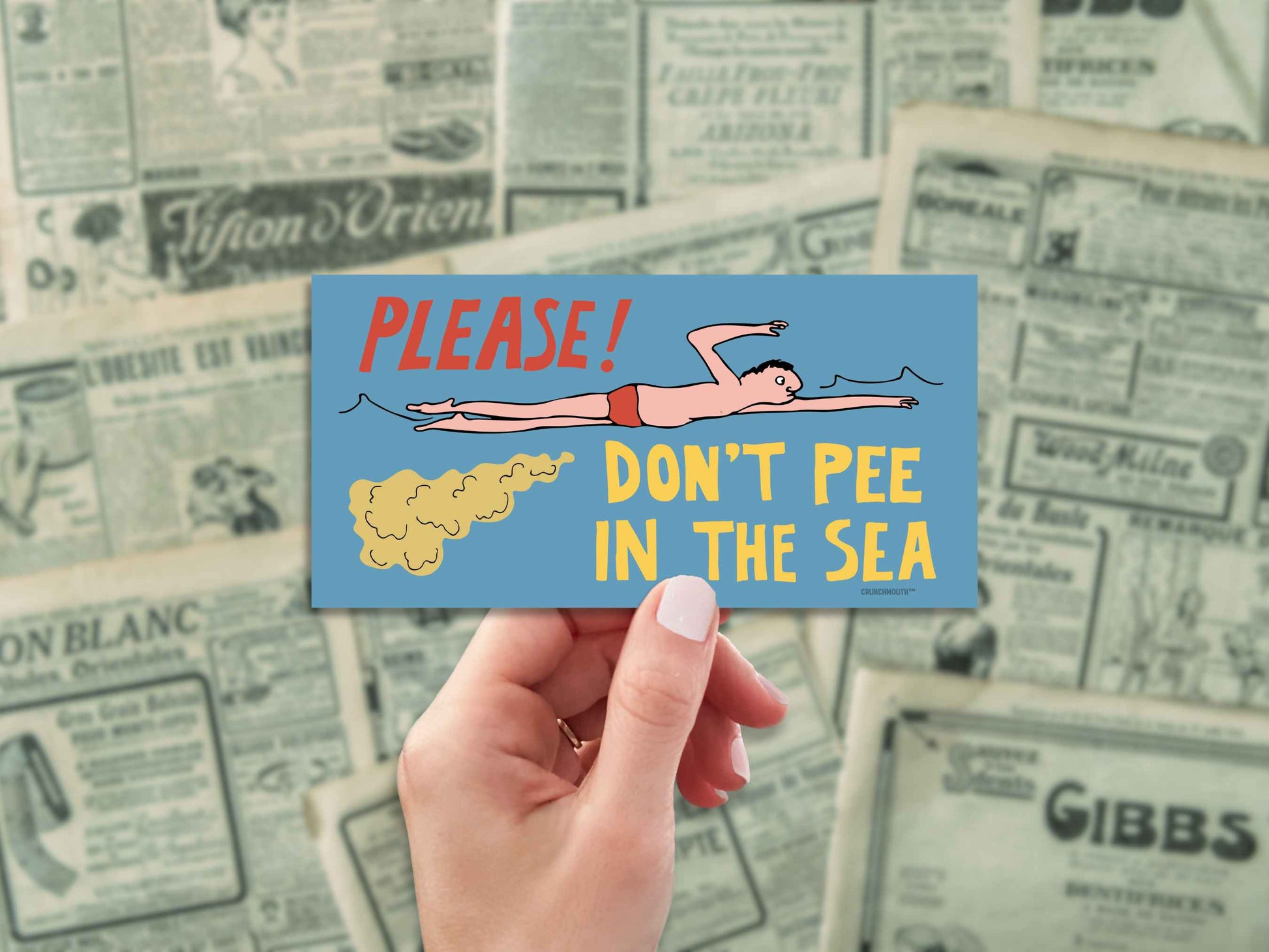please don't pee in the sea funny bumper sticker, hand display, antique newspaper ads background