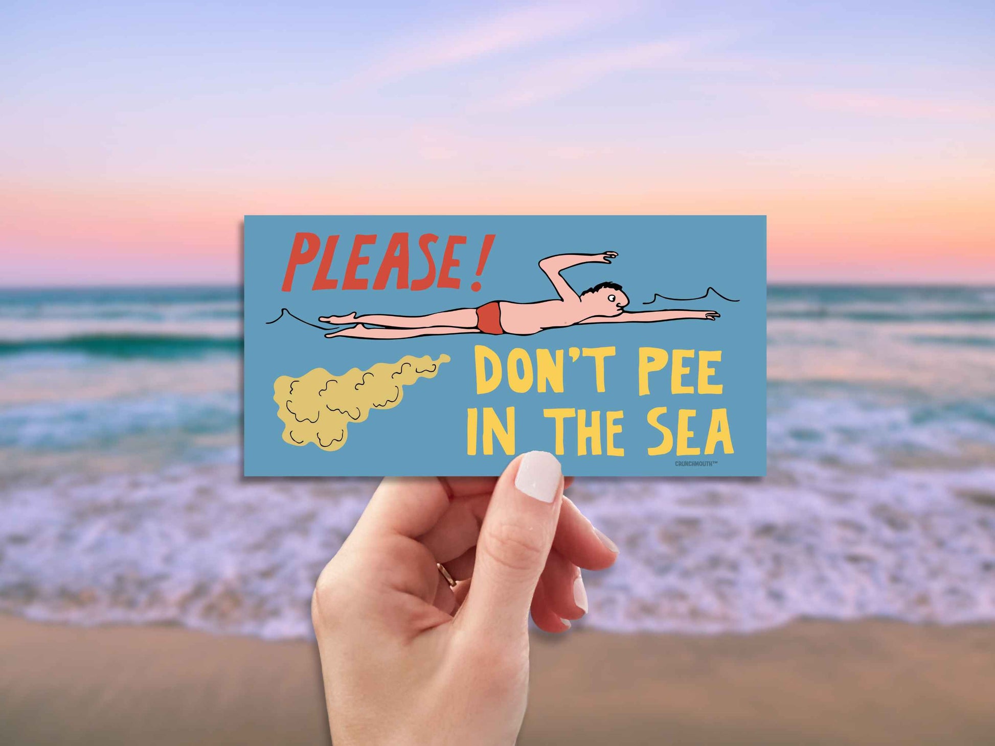 please don't pee in the sea funny bumper sticker, hand display, beach ocean background