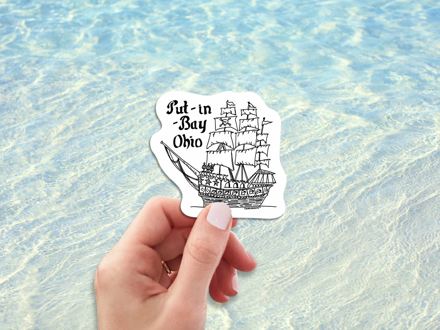 put-in-bay pirate ship travel luggage sticker, hand display, ocean water background