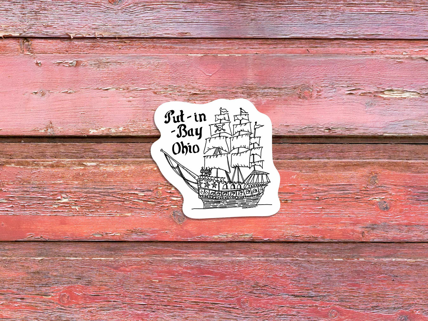 put-in-bay pirate ship travel luggage sticker, red wood panel background